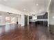 Open concept living space featuring hardwood floors, kitchen, and sliding glass doors to the backyard at 940 S Geneva St, Aurora, CO 80247