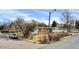 Street view of the property, with a well-maintained lawn and nearby trees at 940 S Geneva St, Aurora, CO 80247