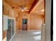 Spacious sunroom with wood walls and ceiling, tiled floor, ceiling fan, and glass door at 940 S Geneva St, Aurora, CO 80247