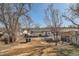 The property boasts a spacious backyard with outbuilding and mature trees at 4611 W 2Nd Ave, Denver, CO 80219