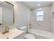 Stylish bathroom features marble tiling, gold fixtures, and a shower-over-tub at 4611 W 2Nd Ave, Denver, CO 80219