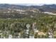 Aerial view showing home's location in a wooded mountain setting at 27218 Mountain Park Rd, Evergreen, CO 80439