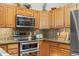 Stainless steel appliances and wood cabinets in a well-lit kitchen at 27218 Mountain Park Rd, Evergreen, CO 80439