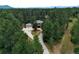 House with driveway and surrounding trees, aerial view at 7350 Fremont Pl, Larkspur, CO 80118