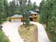 Two-story log home with two car garage and basketball court at 7350 Fremont Pl, Larkspur, CO 80118