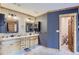 Elegant bathroom with a double vanity and separate toilet area at 7350 Fremont Pl, Larkspur, CO 80118