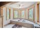 Relaxing bathroom with a large soaking tub and multiple windows at 7350 Fremont Pl, Larkspur, CO 80118