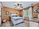 Quaint bedroom with a full-size bed and wood-paneled walls at 7350 Fremont Pl, Larkspur, CO 80118