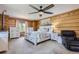 Spacious main bedroom with a king-size bed and wood-paneled walls at 7350 Fremont Pl, Larkspur, CO 80118