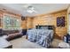 Cozy bedroom with a full-size bed and a pull-out couch at 7350 Fremont Pl, Larkspur, CO 80118