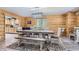 Rustic dining room with wood walls and a large table at 7350 Fremont Pl, Larkspur, CO 80118