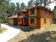 Log home with two-car garage and circular driveway at 7350 Fremont Pl, Larkspur, CO 80118