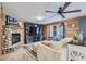 Cozy living room featuring a stone fireplace and large TV at 7350 Fremont Pl, Larkspur, CO 80118