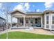 Inviting backyard featuring a covered patio with seating, lush lawn, and well-maintained landscaping at 22580 E Eads Cir, Aurora, CO 80016