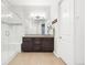 Bright bathroom featuring double sinks, vanity, and a walk-in glass shower with adjacent wall art at 22580 E Eads Cir, Aurora, CO 80016