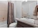 Cozy bathroom features a single sink, shower, tub, and wood-themed shower curtain at 22580 E Eads Cir, Aurora, CO 80016