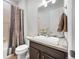 Well-lit bathroom with modern vanity, stylish shower curtain, and decorative wall accents at 22580 E Eads Cir, Aurora, CO 80016