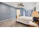 Spacious bedroom with carpeted floors, blue accent wall and ensuite bathroom at 22580 E Eads Cir, Aurora, CO 80016