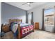 Cozy bedroom with a ceiling fan, carpeted floors, and natural light from the windows at 22580 E Eads Cir, Aurora, CO 80016