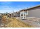 View of the side of a home, showcasing the siding, stone accents, bay window, and adjacent yard at 22580 E Eads Cir, Aurora, CO 80016