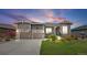 Charming home featuring a well-manicured lawn, stone accents, a two-car garage, and inviting front porch at 22580 E Eads Cir, Aurora, CO 80016
