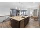 A kitchen island features a stainless steel sink with granite countertops and modern light fixtures at 22580 E Eads Cir, Aurora, CO 80016