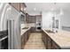Modern kitchen featuring stainless steel appliances, dark wood cabinets, and a large island at 22580 E Eads Cir, Aurora, CO 80016