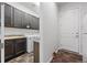 Functional laundry room featuring ample cabinetry, modern washer/dryer, and convenient sink at 22580 E Eads Cir, Aurora, CO 80016