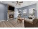 Comfortable living room with a stone fireplace, a wooden coffee table and a ceiling fan at 22580 E Eads Cir, Aurora, CO 80016