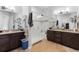 A main bathroom featuring double sinks, vanity, a glass shower, and neutral accents at 22580 E Eads Cir, Aurora, CO 80016