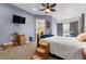 A spacious main bedroom with a blue accent wall, plush carpeting, and a ceiling fan at 22580 E Eads Cir, Aurora, CO 80016