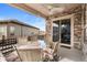 Covered patio features a ceiling fan and stylish stone accents to enjoy outdoor living at 22580 E Eads Cir, Aurora, CO 80016