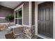 Cozy covered porch with chairs, table and lovely stone accents, perfect for enjoying quiet moments outdoors at 22580 E Eads Cir, Aurora, CO 80016