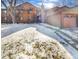 Attractive exterior of a two-story townhome with snow-covered landscaping and attached garage at 9010 W 88Th Cir, Westminster, CO 80021