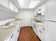 Clean and bright kitchen with white cabinets, neutral countertops and wood flooring at 9010 W 88Th Cir, Westminster, CO 80021