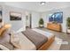 Virtually staged main bedroom with a dresser, large bed, and en-suite bathroom at 9010 W 88Th Cir, Westminster, CO 80021