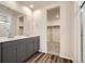 Bathroom features a double sink vanity with gray cabinets and a walk-in closet at 553 Homestead Ave, Brighton, CO 80601