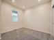 Bright bedroom features neutral walls, plush carpeting, and a window letting in natural light at 553 Homestead Ave, Brighton, CO 80601