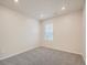 Cozy carpeted bedroom featuring a window and neutral wall paint at 553 Homestead Ave, Brighton, CO 80601