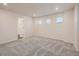 Spacious bedroom with neutral paint, gray carpet, and a bright, naturally lit space at 553 Homestead Ave, Brighton, CO 80601