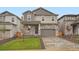 Charming two-story home showcasing a modern design with stone accents and a well-manicured lawn at 553 Homestead Ave, Brighton, CO 80601
