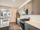 Modern kitchen featuring stainless steel appliances, gray cabinets, and a center island at 553 Homestead Ave, Brighton, CO 80601