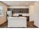 Modern kitchen featuring a center island, stainless steel appliances, and gray cabinetry at 553 Homestead Ave, Brighton, CO 80601