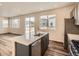 Modern kitchen featuring stainless steel appliances, gray cabinets, and a center island at 553 Homestead Ave, Brighton, CO 80601