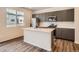 Stylish kitchen with an island, stainless steel appliances, and plenty of natural light at 553 Homestead Ave, Brighton, CO 80601