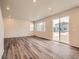 Spacious living room featuring sleek flooring and ample natural light at 553 Homestead Ave, Brighton, CO 80601