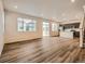 Bright, open living space with sleek hardwood flooring, recessed lighting, and stainless steel appliances at 553 Homestead Ave, Brighton, CO 80601