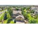 Aerial view of the home showing the manicured lawn, mature trees, and spacious two-car garage at 16500 Hitching Post Cir, Parker, CO 80134