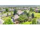 Aerial view showcases a beautifully landscaped home with mature trees and a fenced yard, with a three-car garage at 16500 Hitching Post Cir, Parker, CO 80134