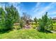 Backyard featuring vibrant landscaping, a rock water feature, and a classic wood fence at 16500 Hitching Post Cir, Parker, CO 80134